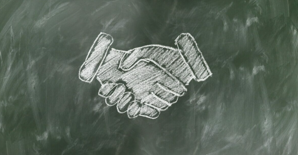 Blackboard chalk sketch of two-hand handshake