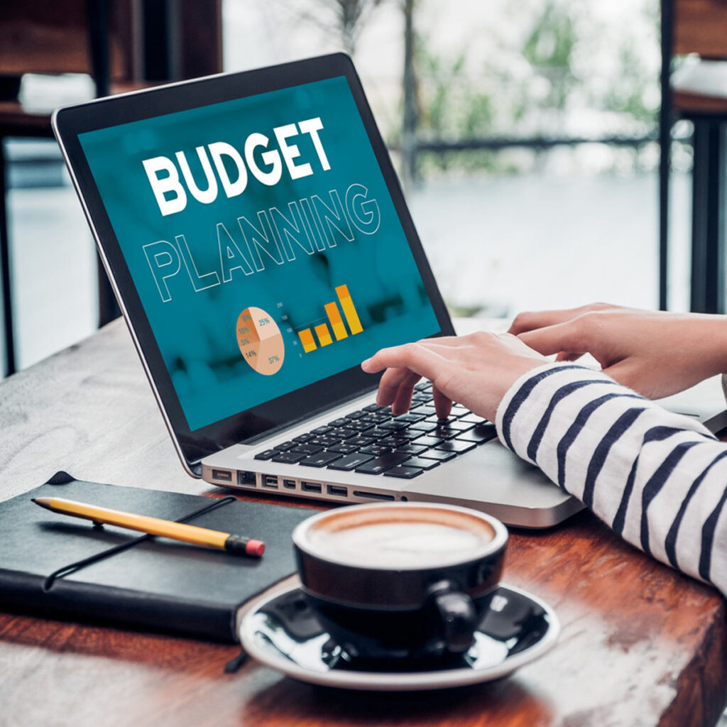 Close up hand of influencer budget planning for online media advertising at cafe restaurant online marketing concept