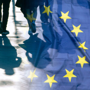 EU or European Union Flag and shadows of people, concept political picture