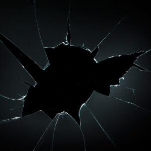 broken cracked glass with hole in black background