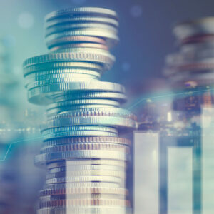 Double exposure of city and graph on rows of coins for finance and banking concept