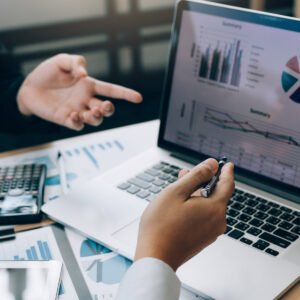 Colleagues are stress talking about the results report and compared with the financial information on the laptop screen.