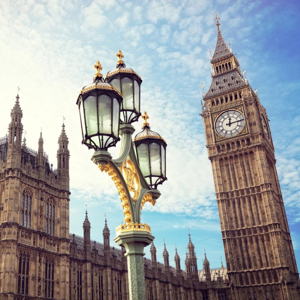 Big Ben in London with the houses of parliament and ornate street lamp