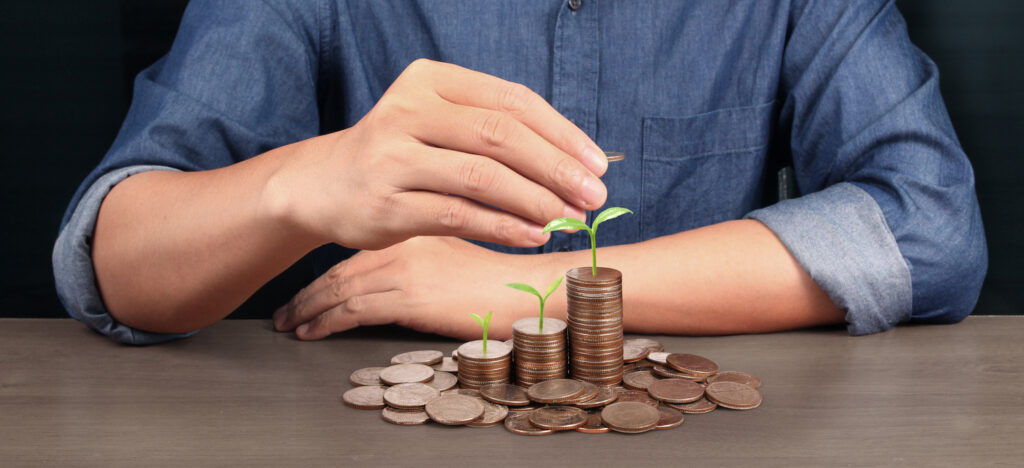 Coins stacked on each other in different positions,Man hand in business casual money