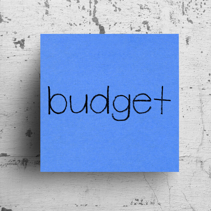 Sticky note on concrete wall, Budget